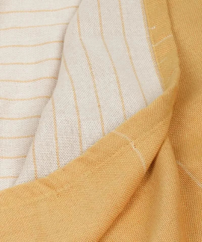 Close-up of sunset gold fabric with subtle pattern