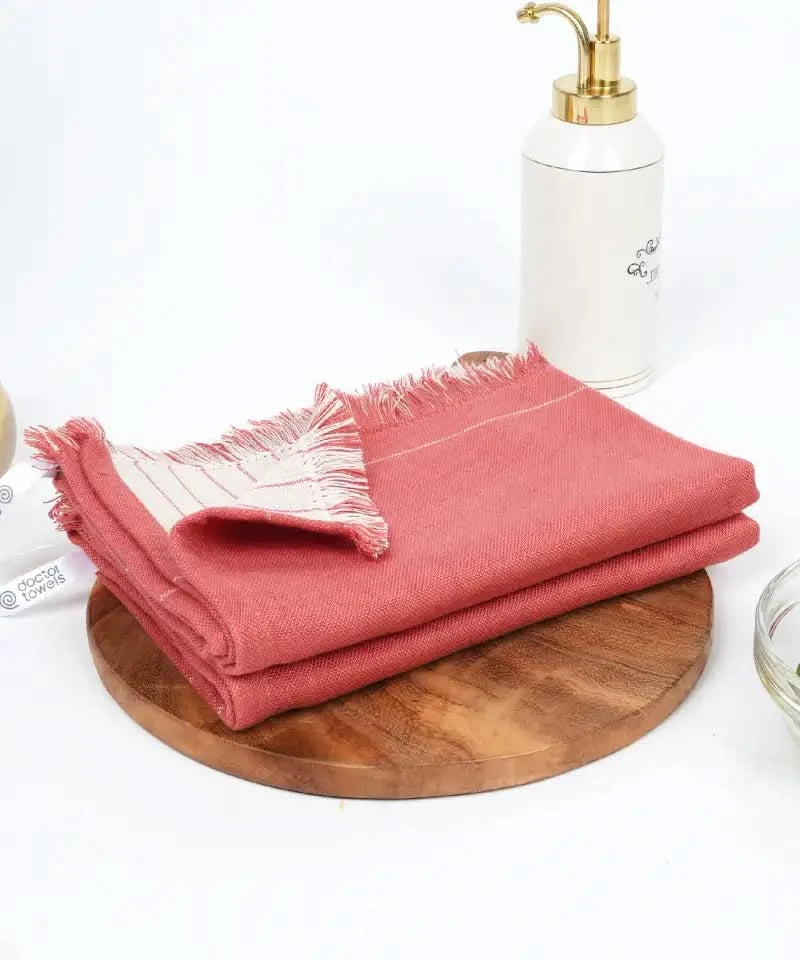 Aloevera towel on a wooden tray with a white container and gold faucet in the background