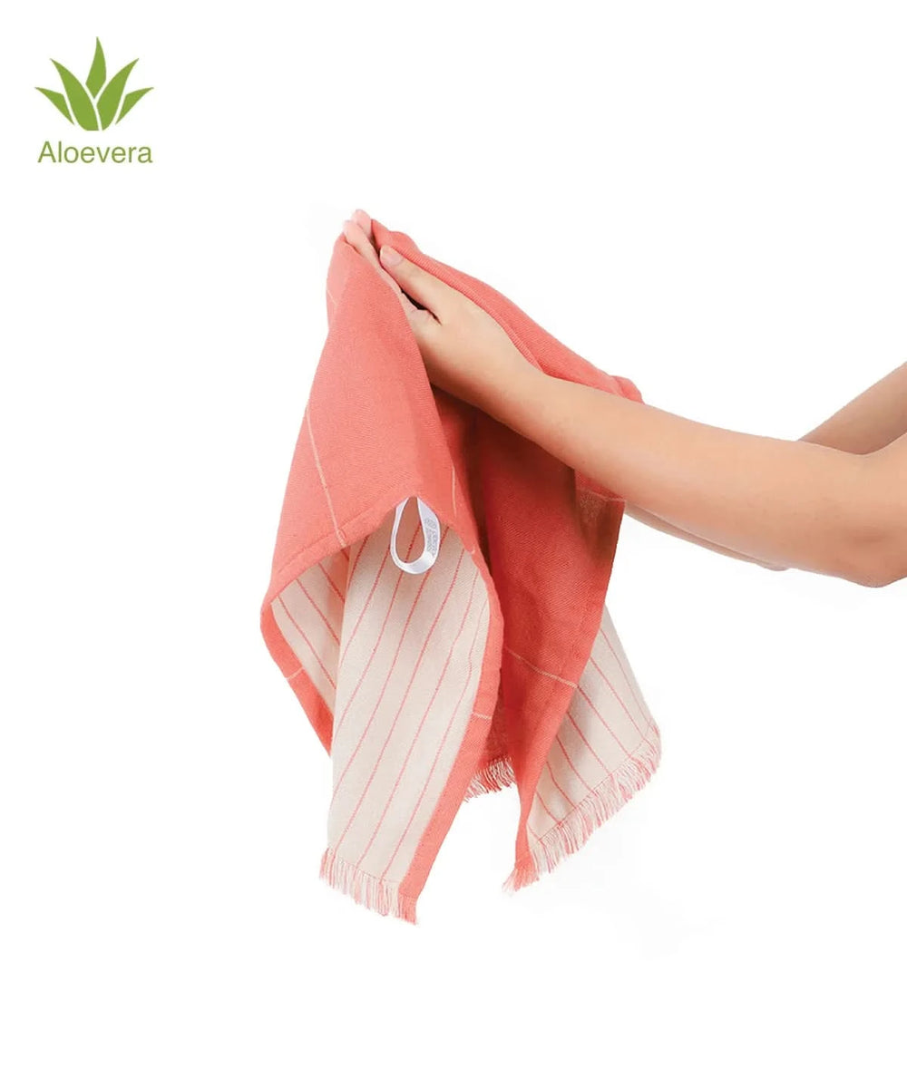 Person holding a apricot brandy towel with a white stripe, branded 'Aloevera' on a white background
