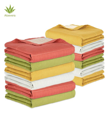 Stack of folded colorful aluvera towels with Aloevera logo on a white background