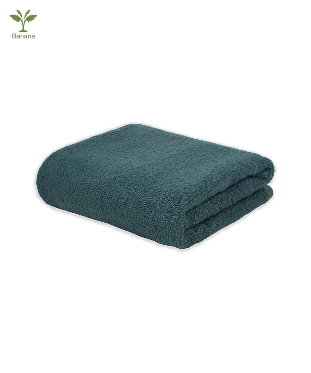 Folded terry gym towel on a white background with a brand logo in the corner.