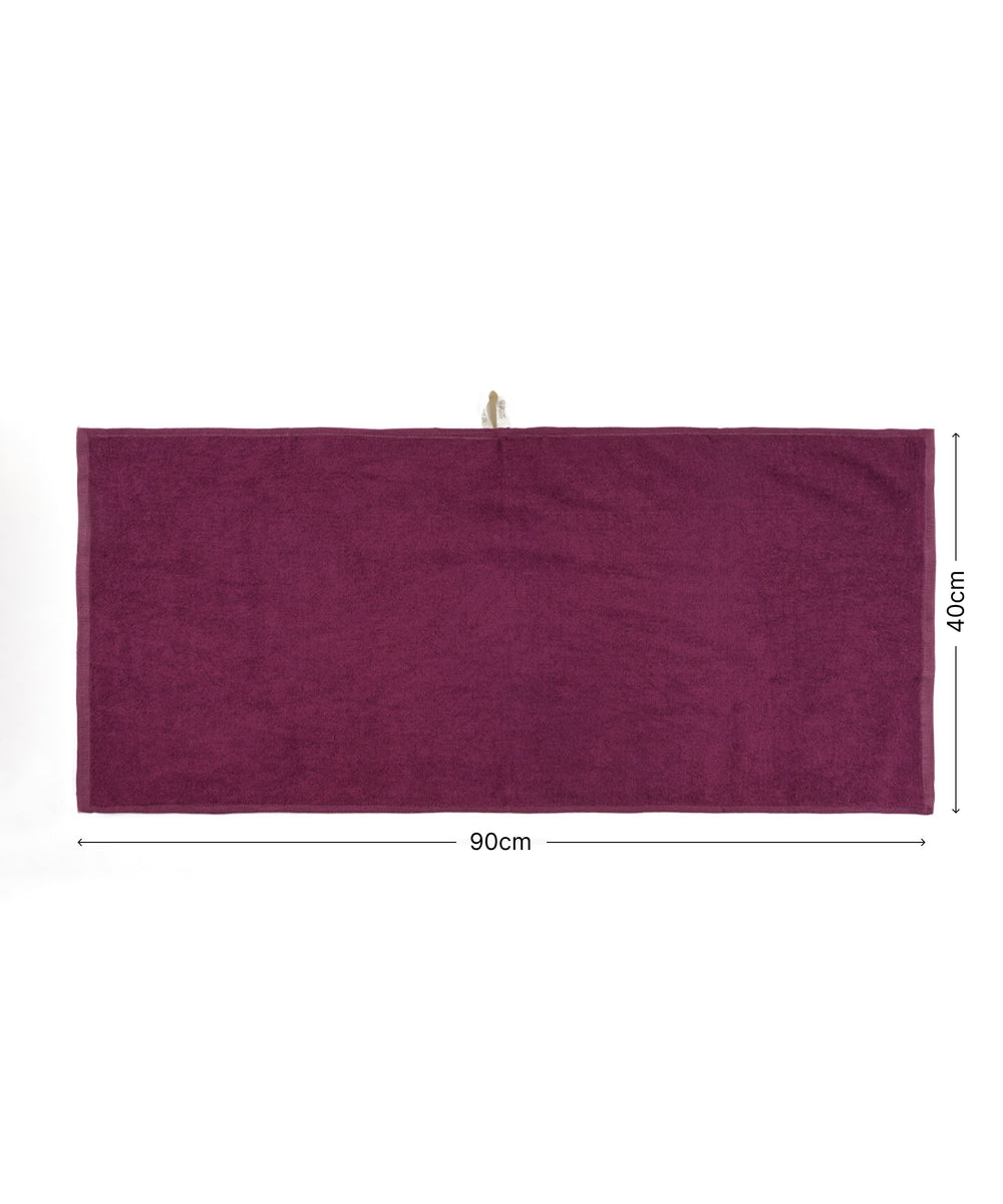 Burgundy towel with dimensions on a white background