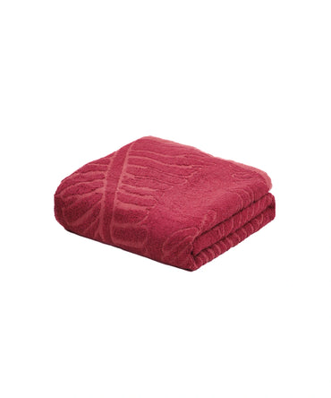 Folded red blanket on a white background