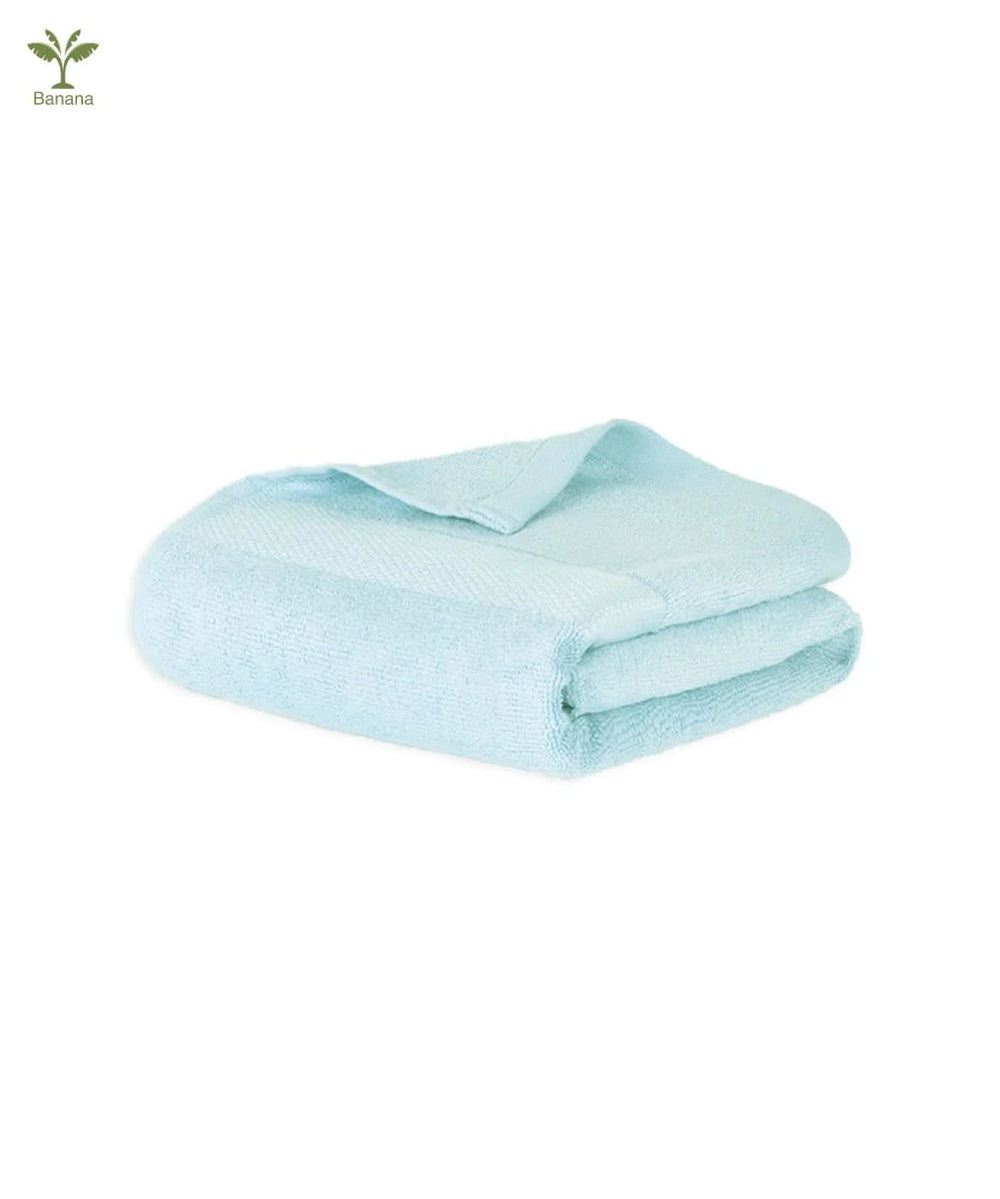 Folded light blue super light terry towel on a white background.