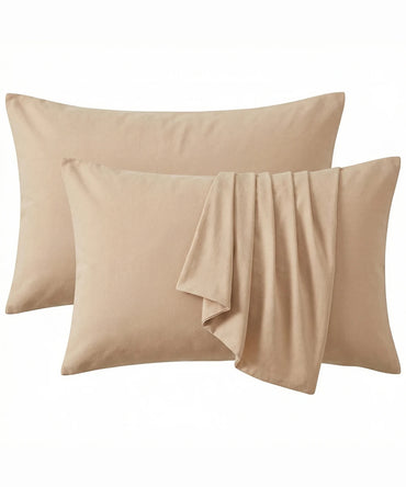 Two Frozen Dew pillows with a folded beige fabric on a white background