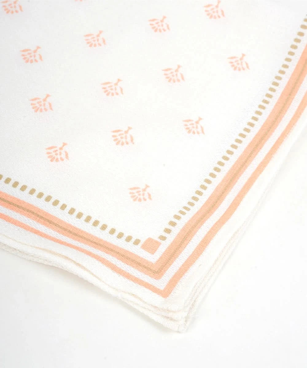 White napkin with pink floral pattern and border on a white background