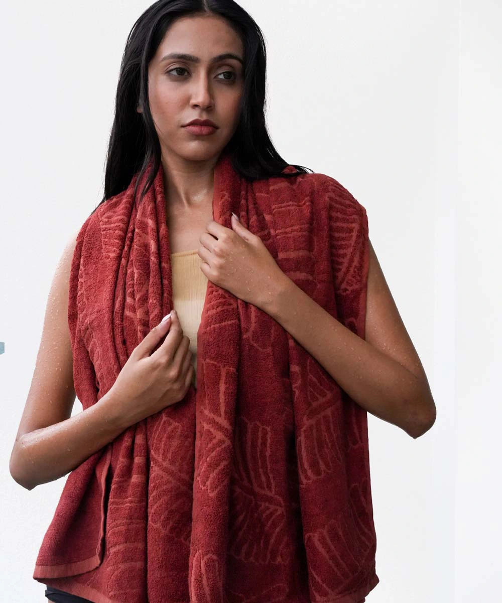 Woman wearing a red patterned scarf on a white background