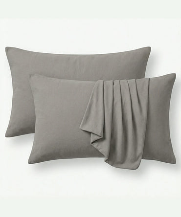 Two Moon mist pillows and pillowcases with a folded on a white background.