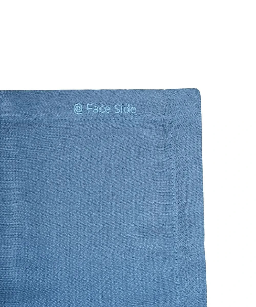 Close-up of a blue fabric of pillowcase with 'Face Side' text on a white background