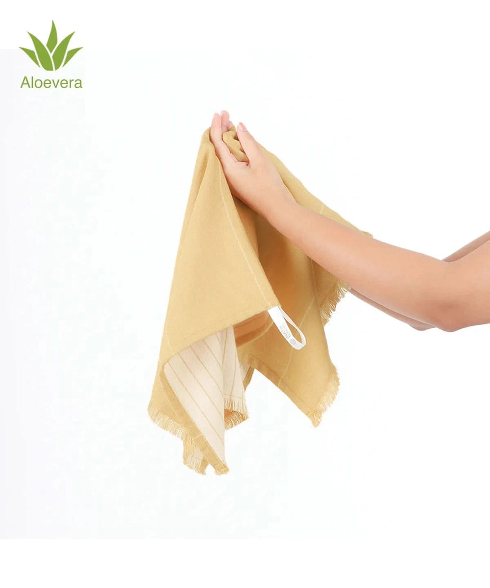 Hand holding a yellow aloevera double cloth towel with 'Aloe vera' branding on a white background
