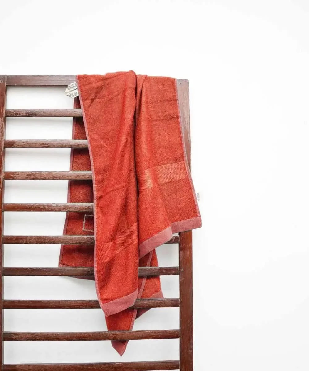 Red towel draped over a wooden ladder against a white background