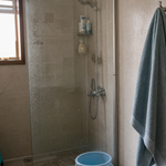 Freshly hung blue bath towel in a compact humid bathroom