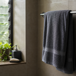Bath towel hanging in a compact humid bathroom