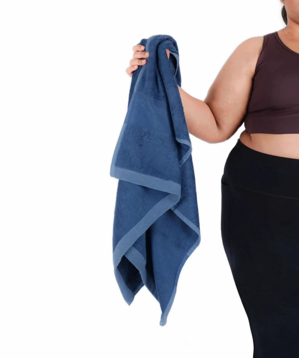 Person holding a blue towel against a white background