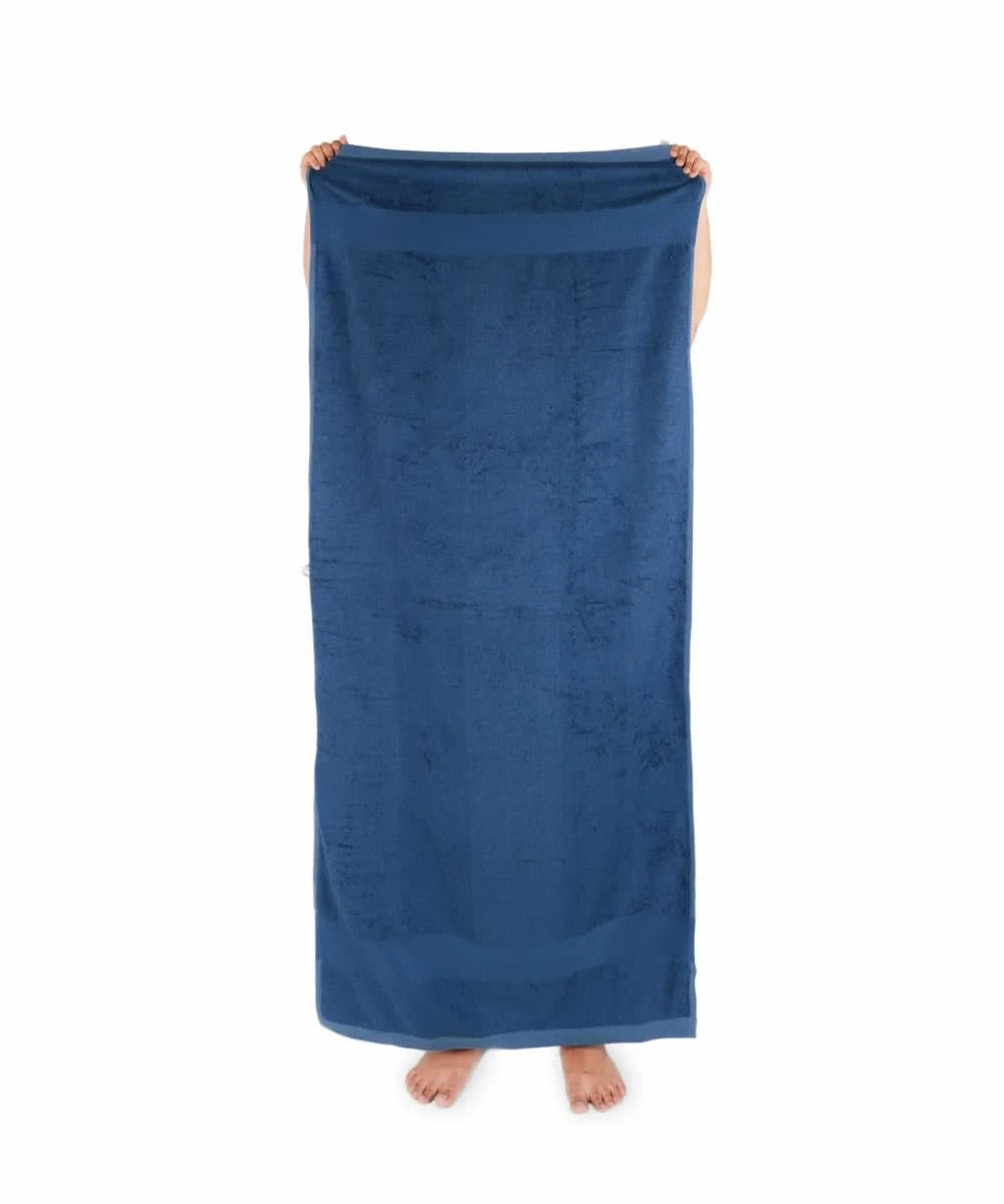 Person holding a blue towel on a white background
