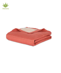 Folded red towel with a visible aloe vera icon on a white background