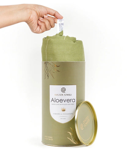 Aloe vera towel in a cylindrical container with a hand lifting a towel from it.