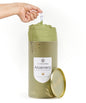 Aloe vera towel in a cylindrical container with a hand lifting a towel from it.