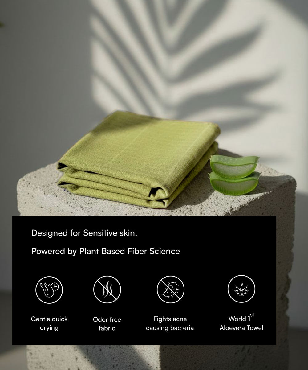 Green towel on a stone surface with aloe vera slices and product features text overlay.