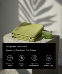 Green towel on a stone surface with aloe vera slices and product features text overlay.