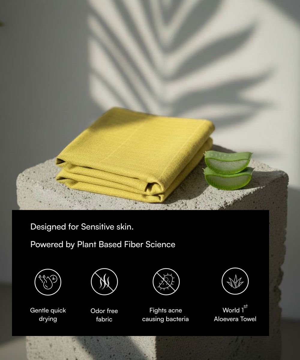 Yellow towel on a stone surface with aloe vera slices and product features text overlay.