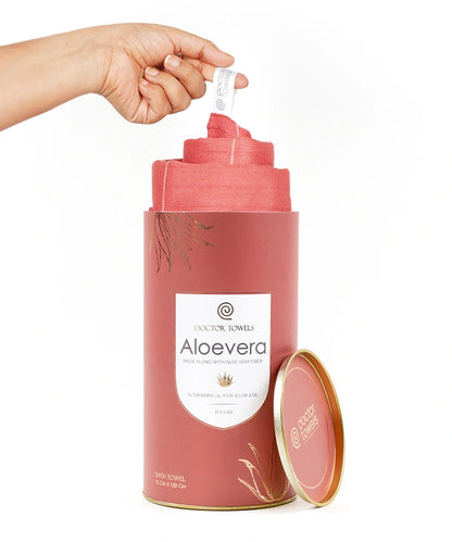 Hand pulling a red ( Apricot Brandy ) aloe vera sheet from a cylindrical container labeled 'Aloevera' on a white background.