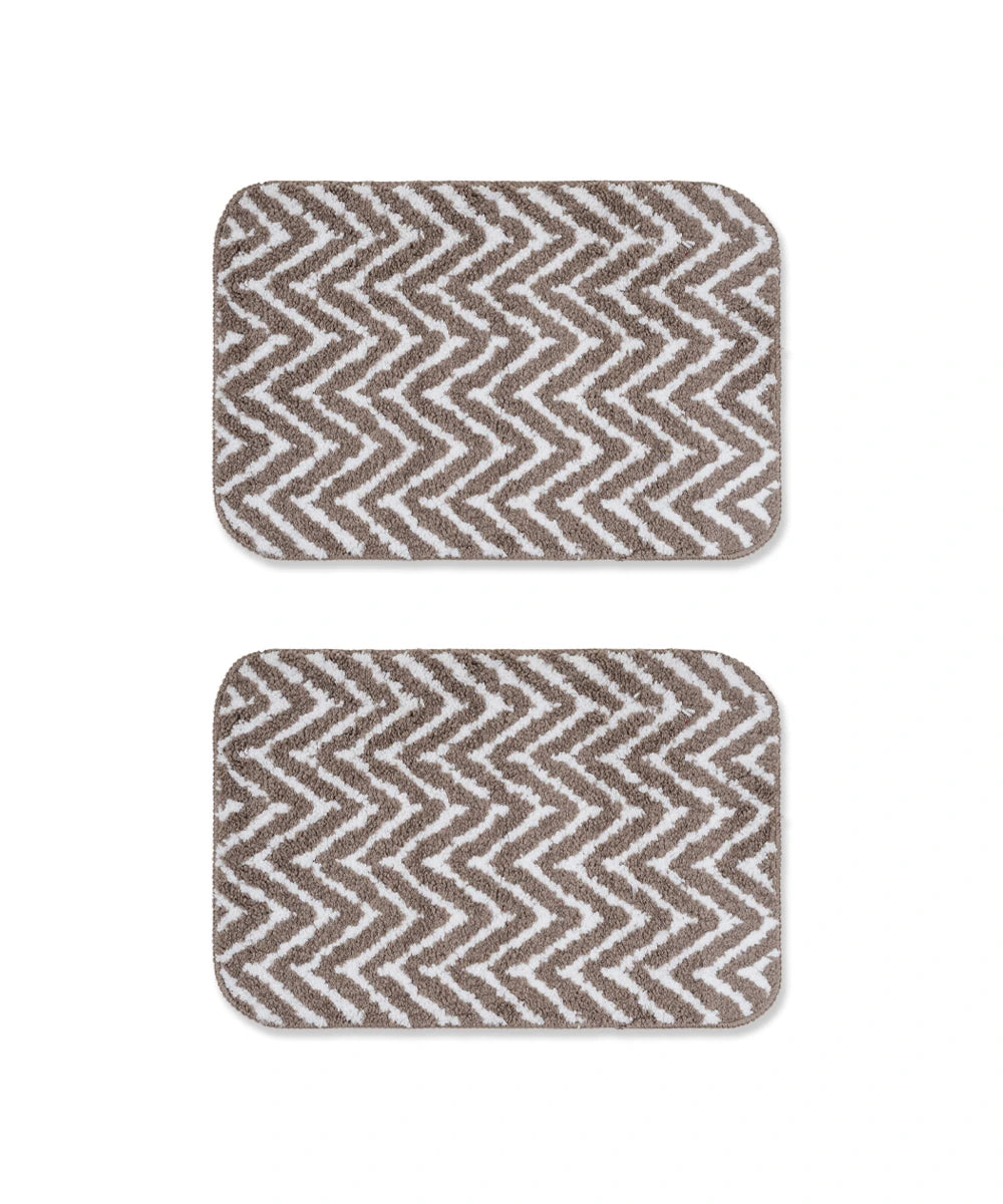 Two arrow printed bath mats on a white background