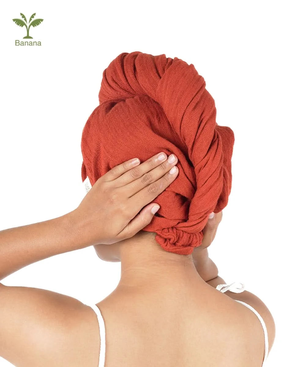 Person wearing a terracotta hair towel with a white background