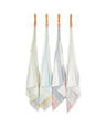 Set of four colorful bamboo dobby towels hanging on a line against a white background.