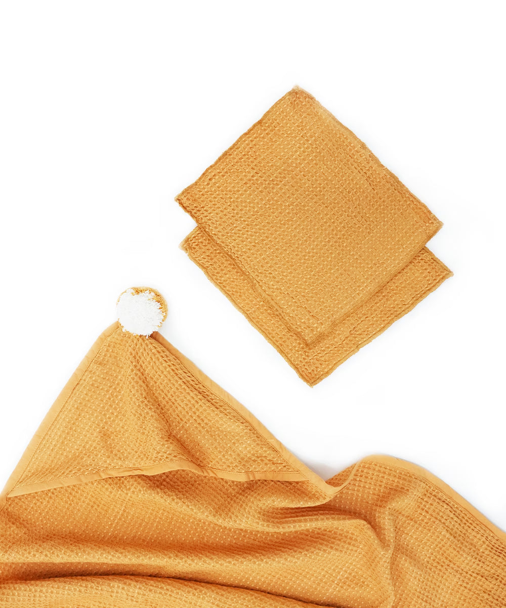 Mustard yellow fabric with a white tag on a white background