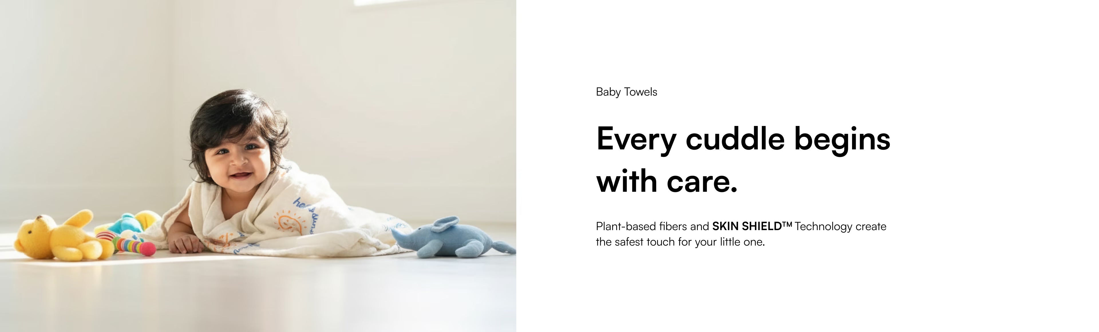 Child lying on a white floor with toys, accompanied by text about baby towels and care.