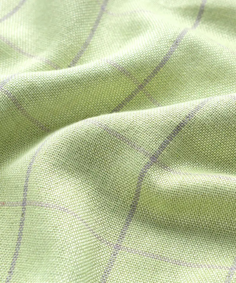 Close-up of Banana Double Cloth Towel - candy green fabric with a subtle pattern