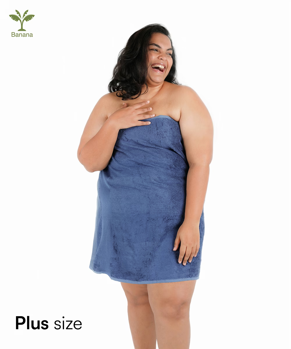 Woman wrapped in a blue towel with 'Plus size' text and Banana icon.