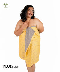 Woman wearing a golden orcher Banana double cloth plus-size towel on a white background