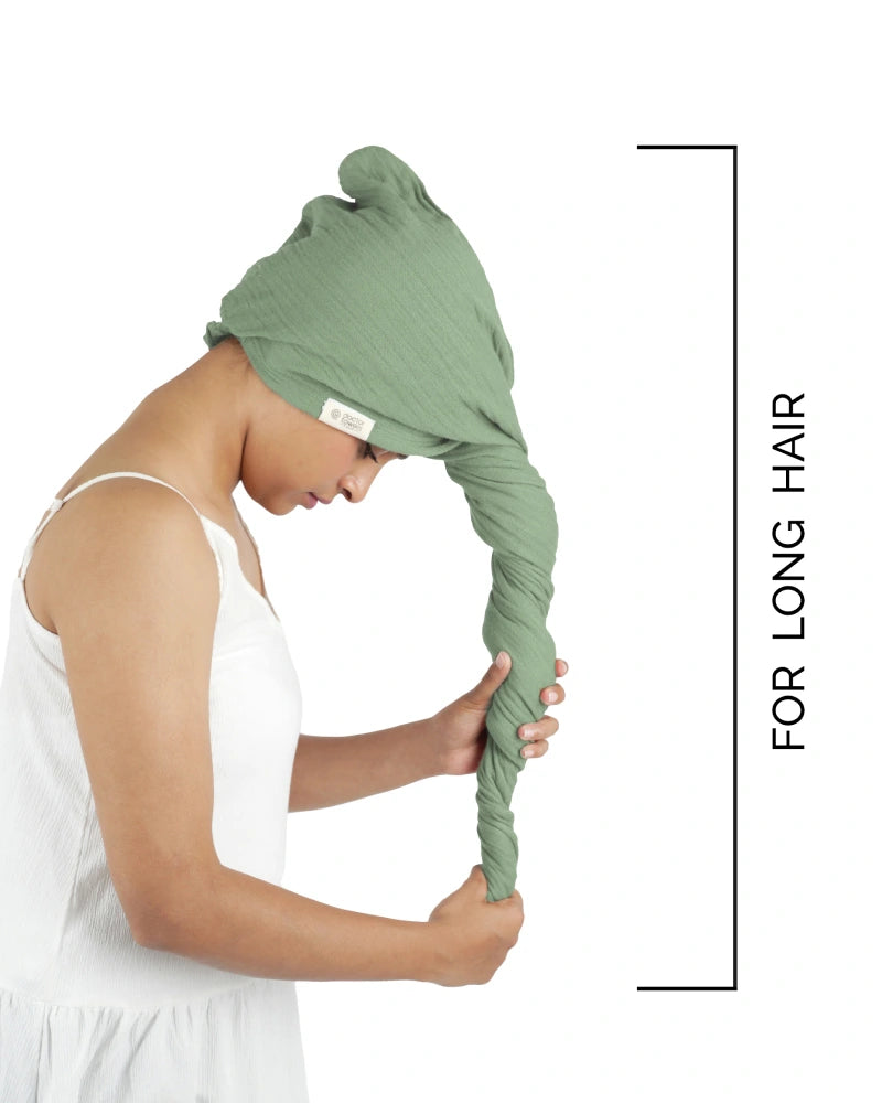 Person using a green hair towel on a white background
