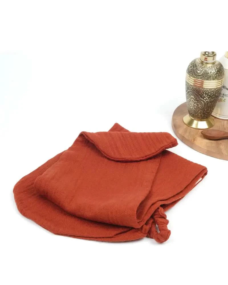Terrracotta hair towel - extra long with a decorative metal container on a white background