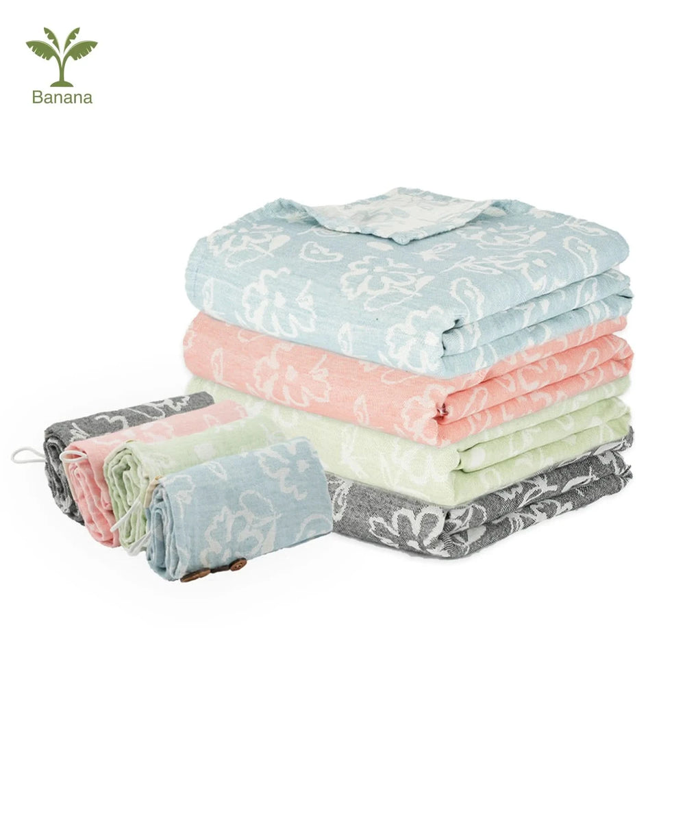 Stack of folded towels in various colors with a brand logo in the corner.