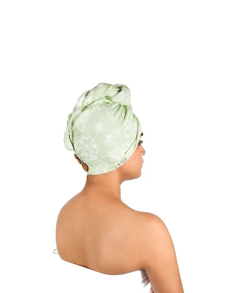 Woman wearing a pastel green patterned headscarf on a white background