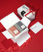 Two towels in a white box , Product packaging with a red ribbon on a red background 