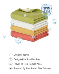 Stack of folded colorful towels with 'Skin Shield' technology label and product benefits listed.