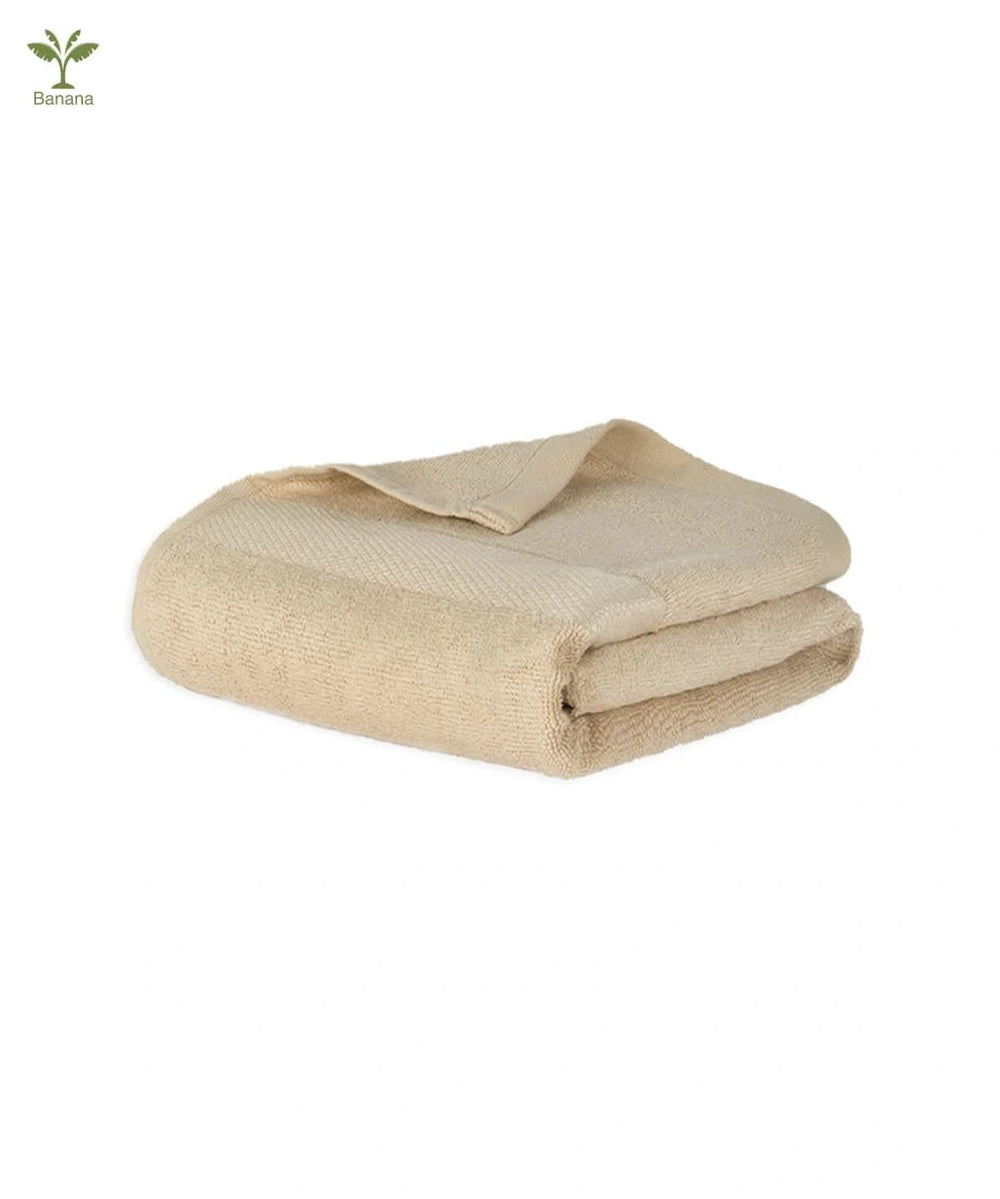 Folded biscotti beige - banana super light terry towel on a white background.