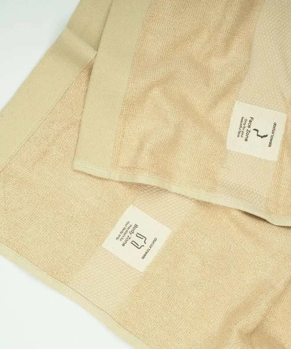 Beige towel with a brand label on a white background