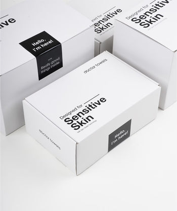 White boxes with 'Sensitive Skin' text and branding on a white background