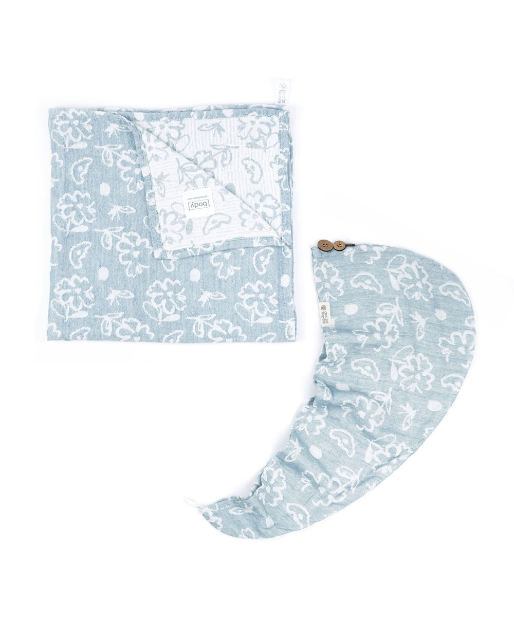 Set of bath towel and hair towel with floral pattern on a white background.