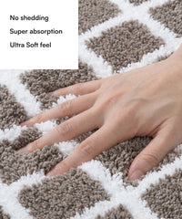 Close-up of a hand touching a checkered bath mat with text highlighting features.