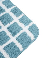 Blue and white checkered bath mat on a white background