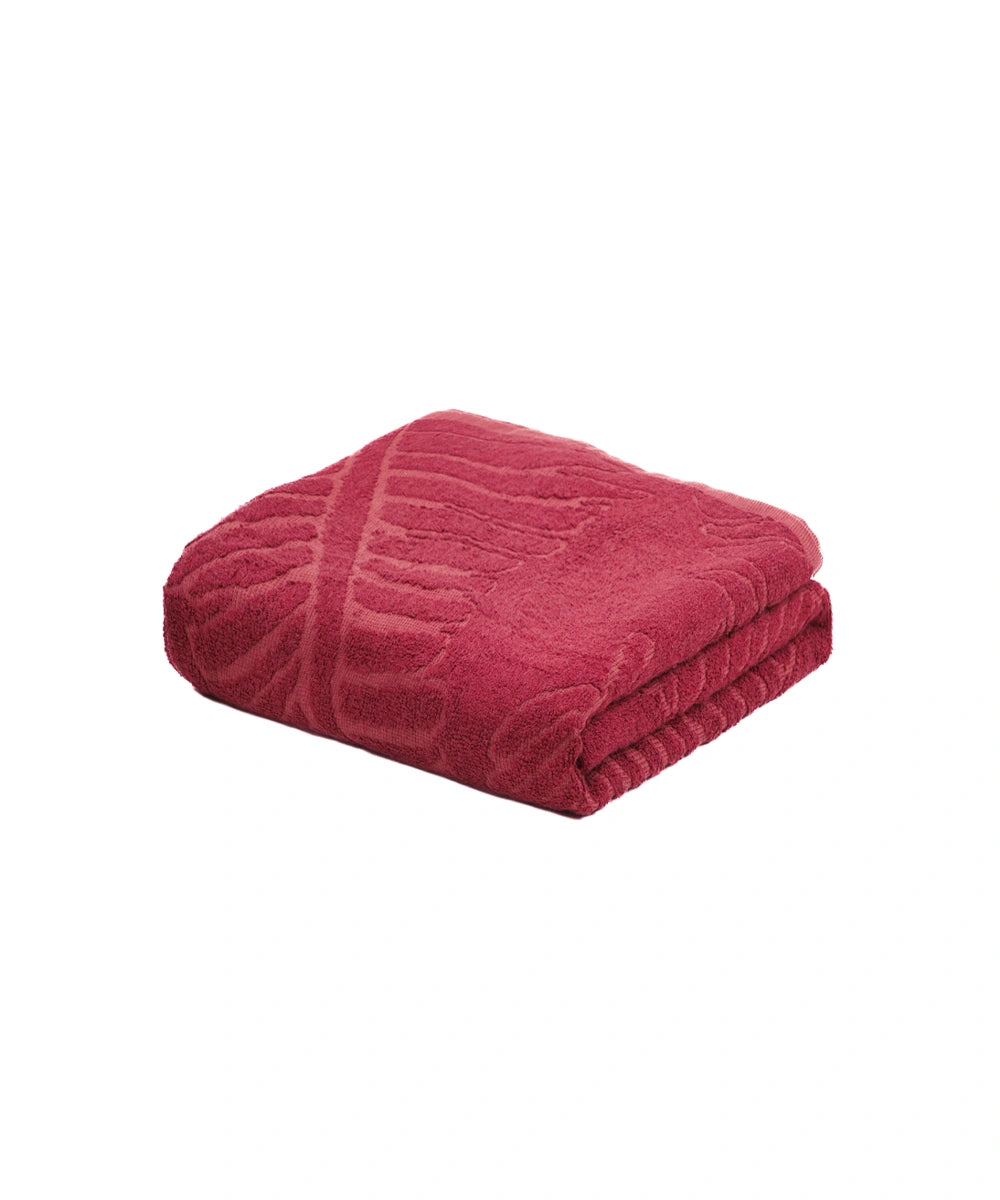 Folded red blanket on a white background
