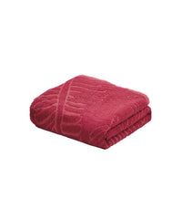 Folded red blanket on a white background