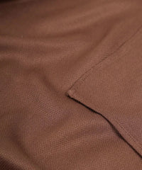 Close-up of brown hand kerchief with a visible seam