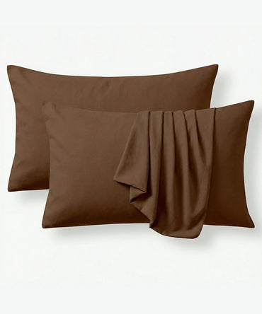 Two chocolate brown pillowcases on a white background